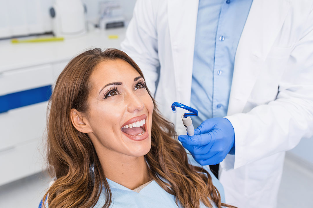 A dentist working on a patient s teeth in a dental office.